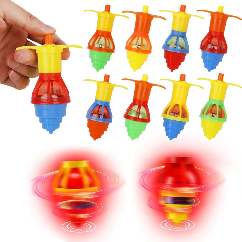 A collection of glow-in-the-dark spinning tops in various colors and shapes, some held by a hand.