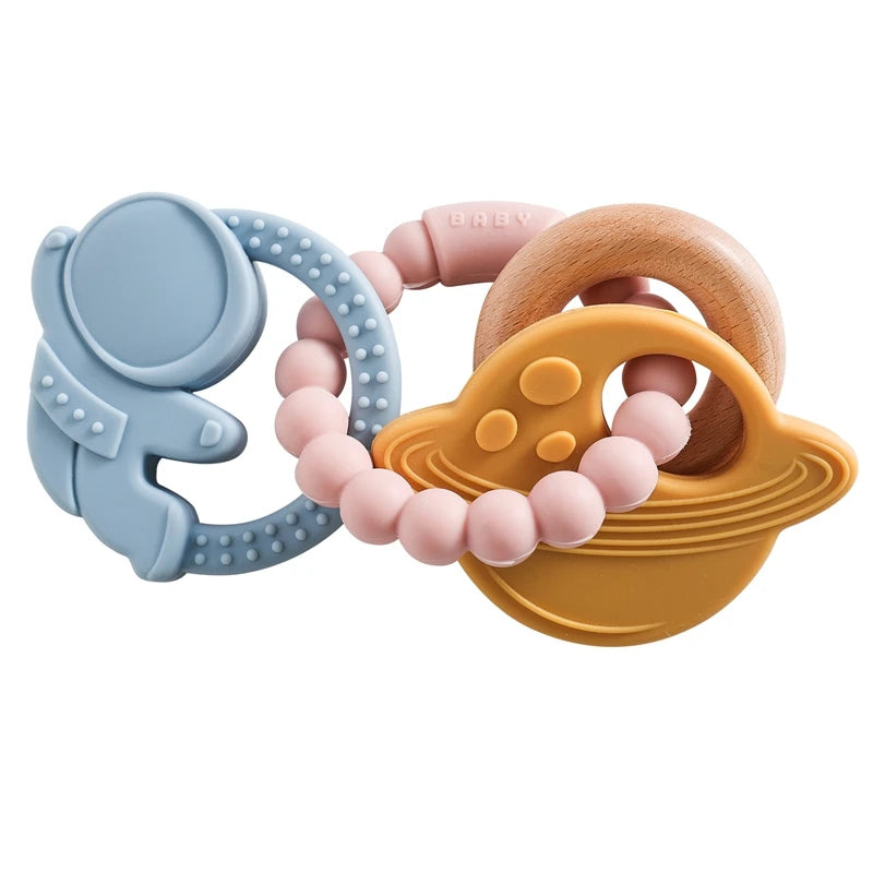 A set of food-grade silicone planet teethers in blue, pink, and wood tones for babies.