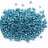 A pile of small, metallic blue glass beads for jewelry making.