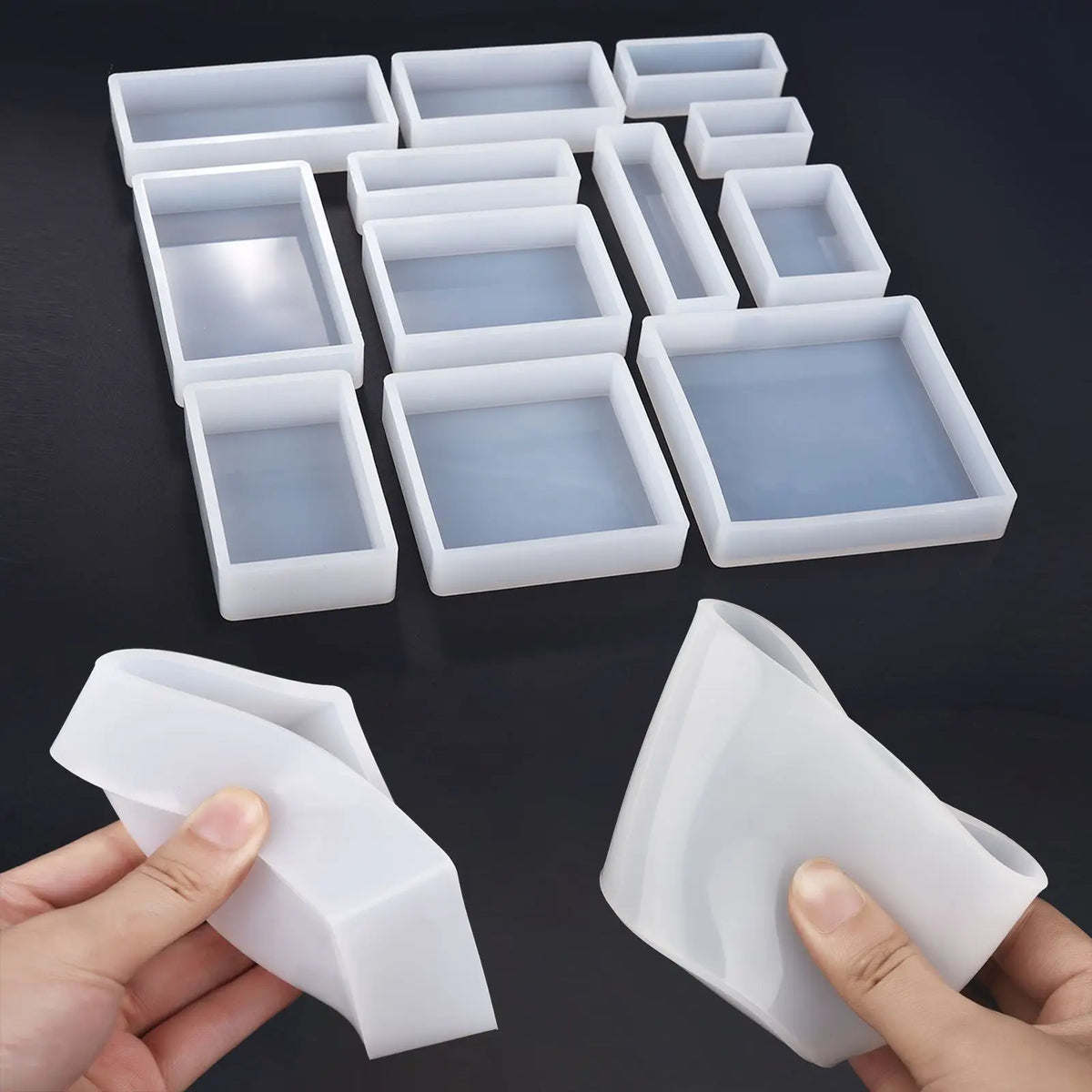 A collection of white geometric resin casting molds and a hand holding one mold.