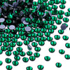 A pile of green glass crystal hot fix rhinestones for DIY crafts and decor.