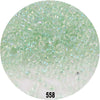 A circular image showing numerous small, round, colorful glass seed beads in various shades of green and clear.