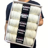 A box containing five skeins of white alpaca wool yarn for knitting and crochet projects.
