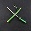 A samurai sword with a green hilt and blade crossed, attached to a silver keychain.