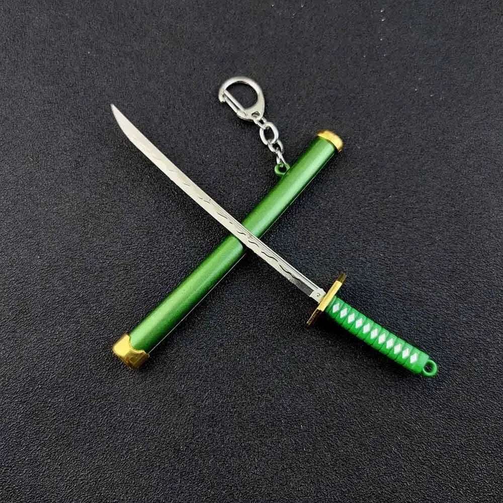 A samurai sword with a green hilt and blade crossed, attached to a silver keychain.