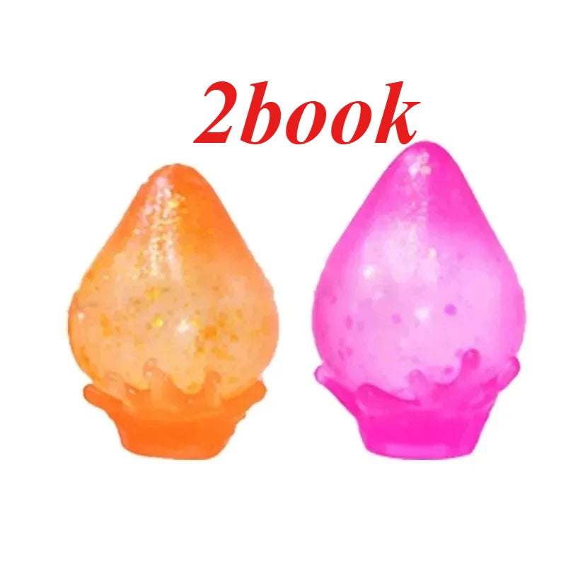 Two squishy toys, one orange and one pink, with glitter texture.