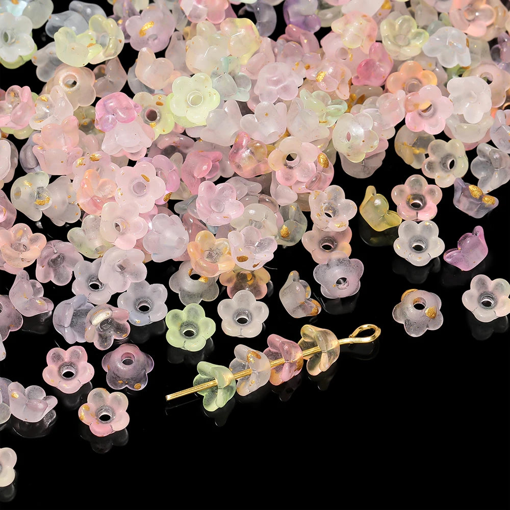 A pile of gradient pink and yellow acrylic bellflower beads for jewelry making