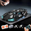 A black remote control sports car model is shown with its components and a hand holding a controller.