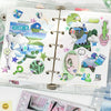 Offenes Art-Papier-Stickerbuch mit farbenfrohen Illustrationen und Dekorationen zum Scrapbooking