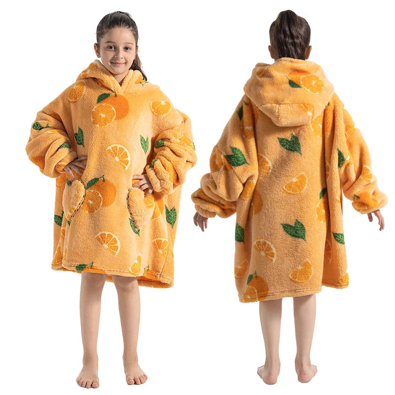 A child models an orange-patterned, fuzzy yellow hoodie sweater for winter.