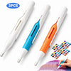 Three white and orange diamond painting pens with automatic bead dispensers shown next to a hand.