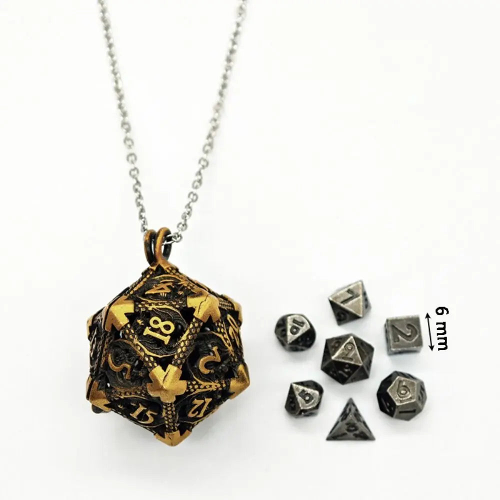 A gold-toned metal polyhedral dice set with a pendant storage case and several individual dice.