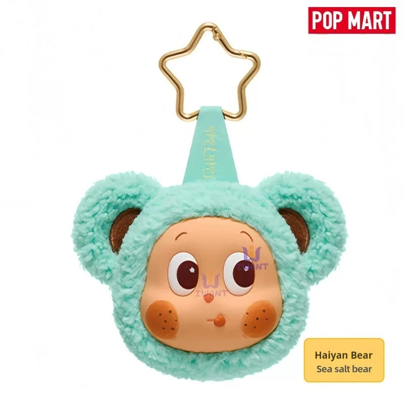 A cute teal fuzzy bear earbud case cover with large eyes and brown accents.