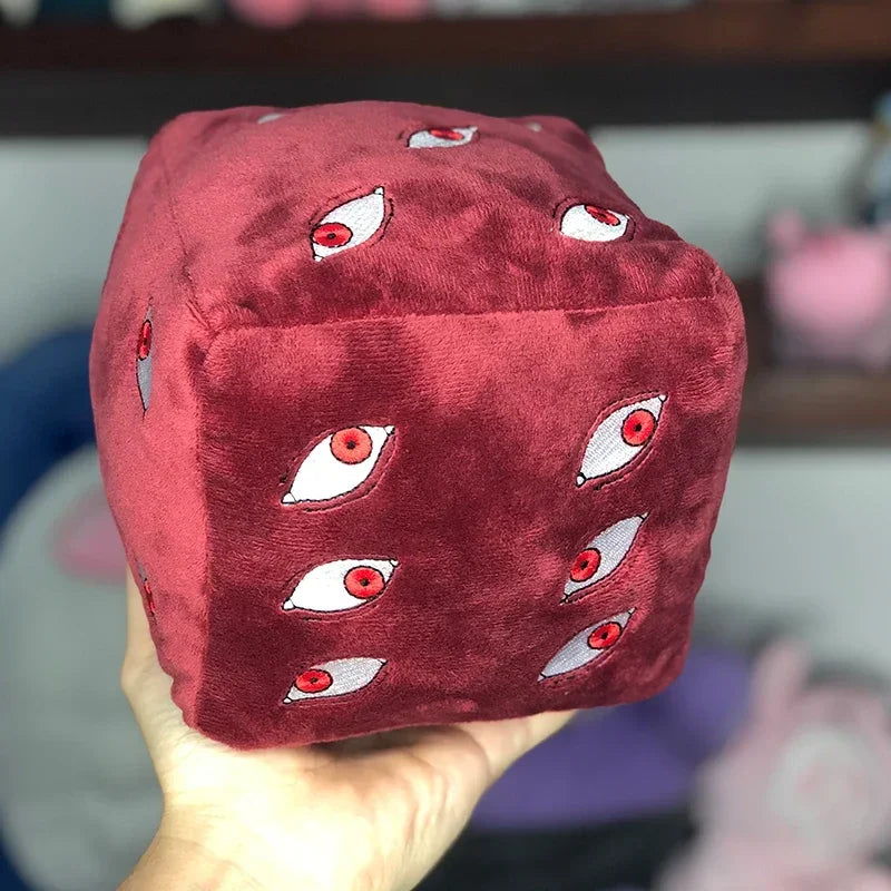 A deep red plush figure of Gojo Satoru featuring multiple stylized eye designs.