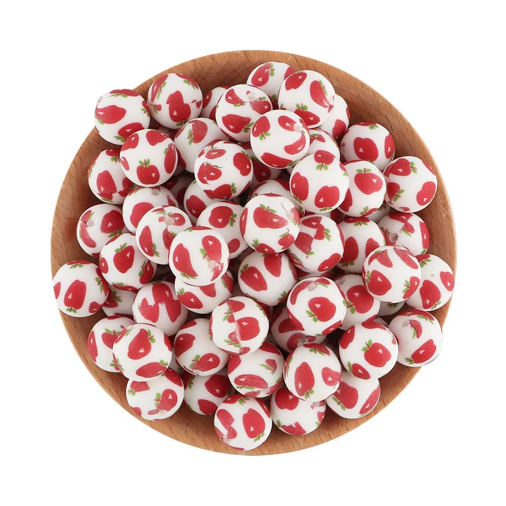 A wooden bowl filled with small, round, red and white silicone beads for jewelry making.