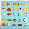 A grid of miniature food items including cakes, wine, and various snacks arranged on a light blue cutting board.
