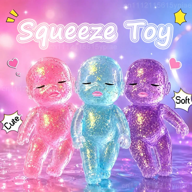 Three squishy baby toys in pink, blue, and purple glitter are displayed against a soft light background.