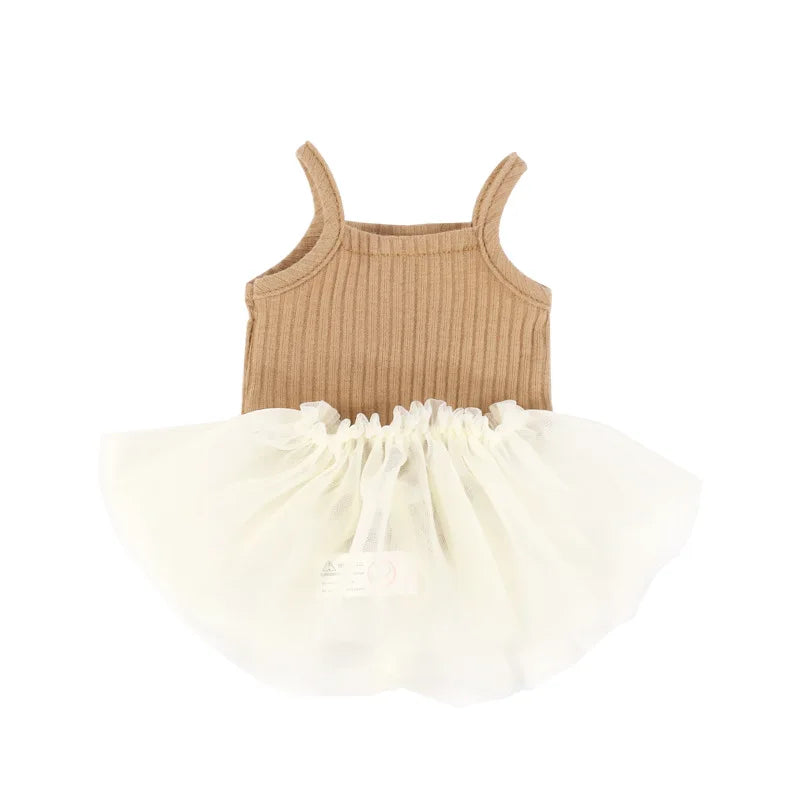 A beige knitted top and ruffled white skirt set for a baby doll.