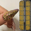 A hand holds a box of gold caviar beads for DIY nail art, showing various mixed sizes and colors.