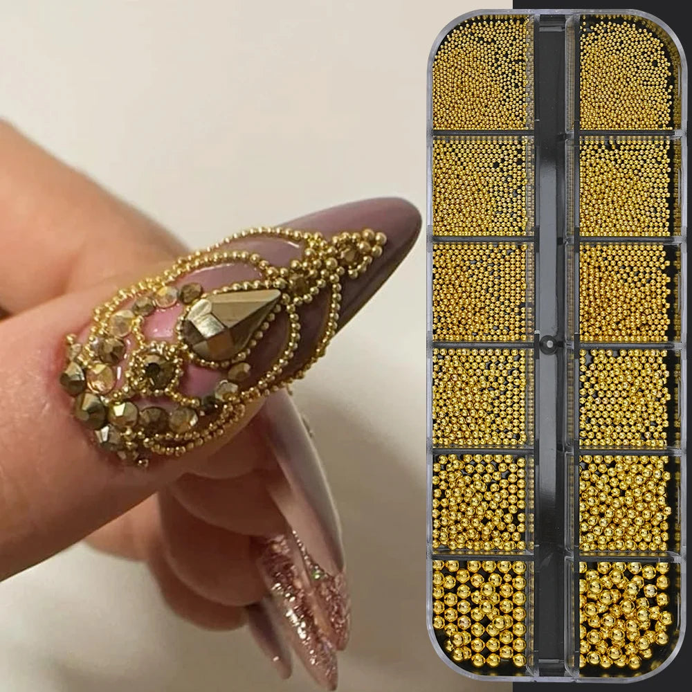 A hand holds a box of gold caviar beads for DIY nail art, showing various mixed sizes and colors.