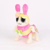 A plush toy of a yellow creature with pink ears and floral accents.