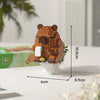 An orange micro building block set of a cute bear figure standing on a white base.