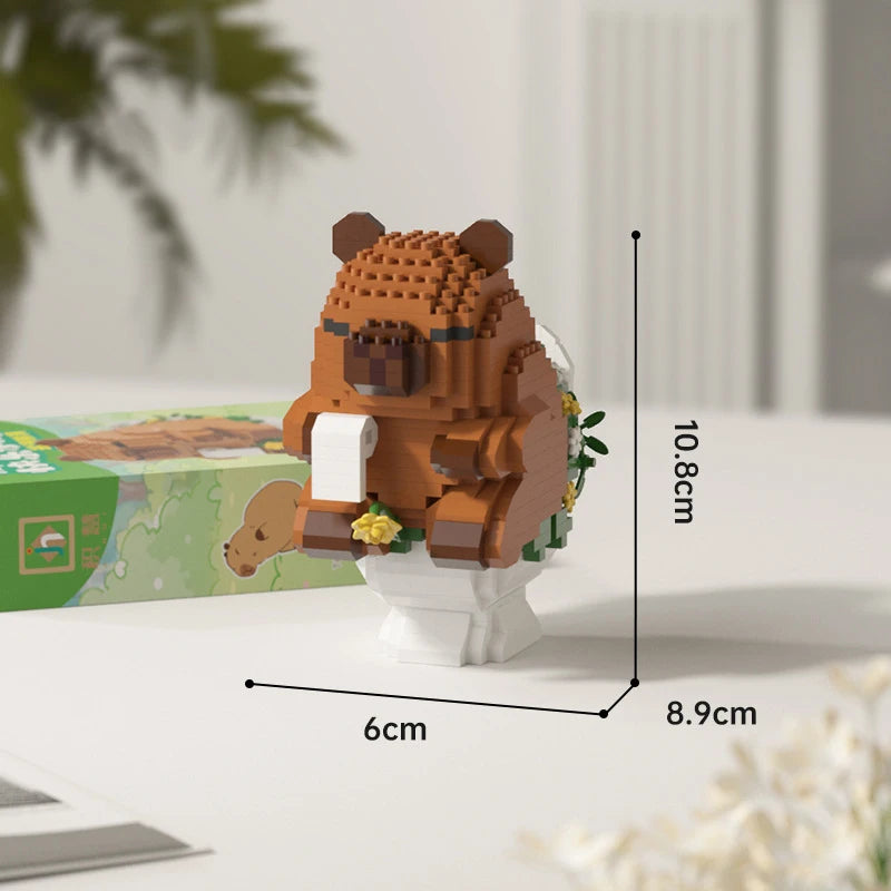 An orange micro building block set of a cute bear figure standing on a white base.
