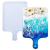 A silicone resin casting mold set featuring a white rectangular tray and a blue wave-shaped mold with embedded stones.