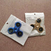 A blue aluminum alloy fidget spinner is shown inside a clear plastic pouch.