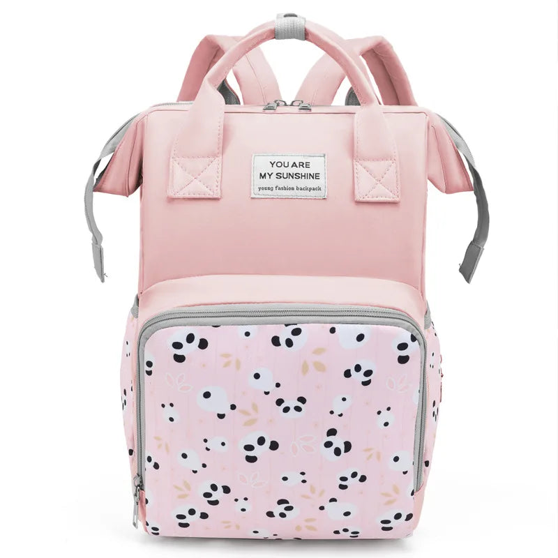 A pink mommy backpack with wet/dry separation features and large capacity.