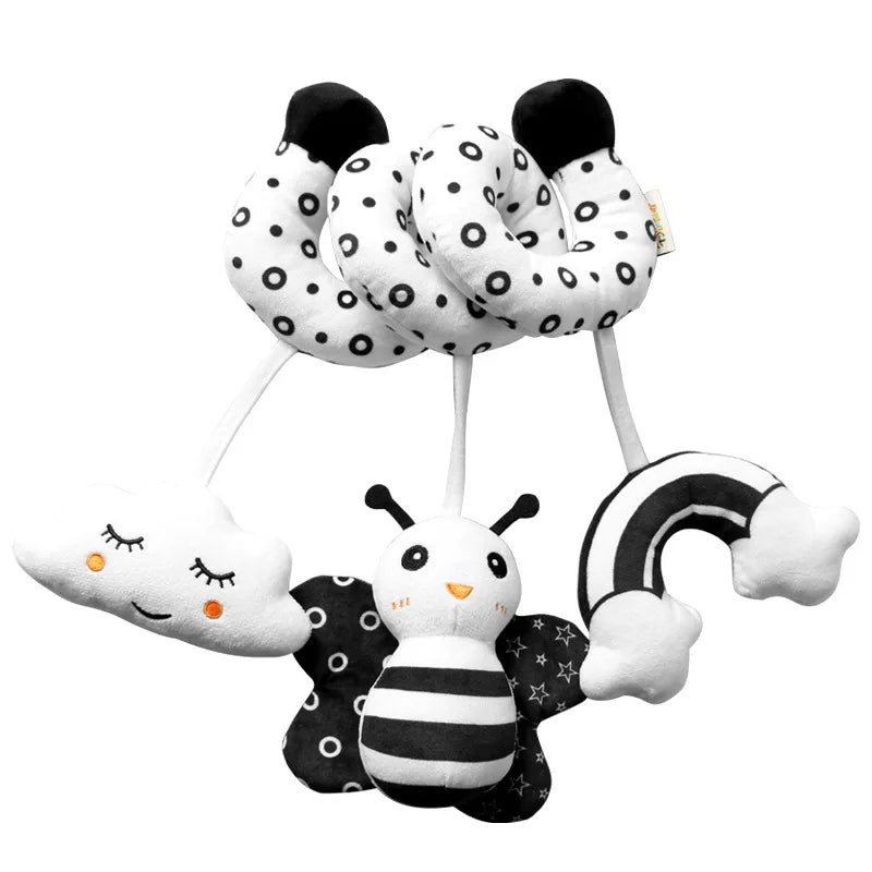 A set of spiral sensory rattles featuring black and white polka dots and a bee design.