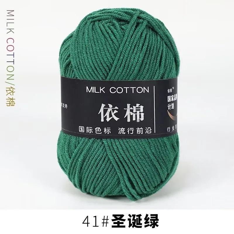 A ball of dark green milk cotton yarn labeled with Chinese characters and a size indicator.