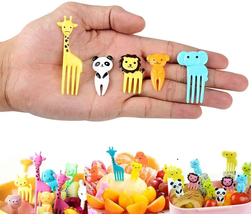 A hand holds a set of colorful mini fruit forks shaped like various animals, including a giraffe, panda, lion, and elephant.