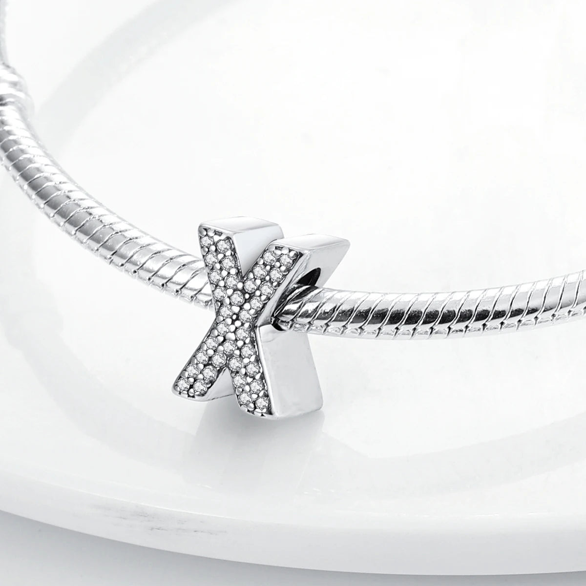 Sterling silver alphabet charm beads featuring an X design encrusted with cubic zirconia
