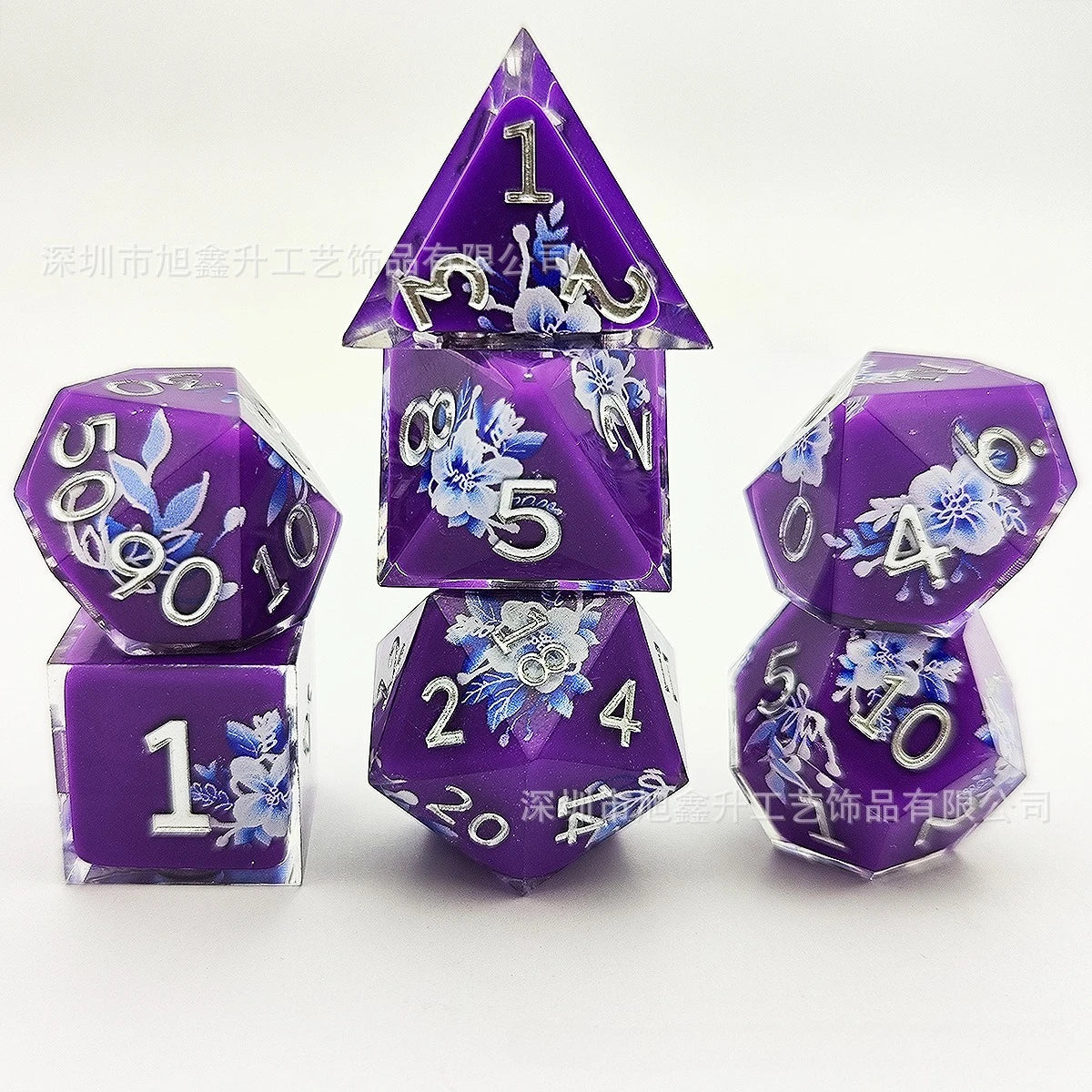A set of purple resin dice featuring a black kitten design and floral accents, displayed on a white background.