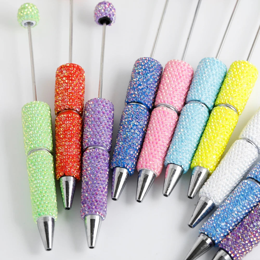 A collection of colorful rhinestone pen blanks in various shades and sizes for DIY jewelry making.