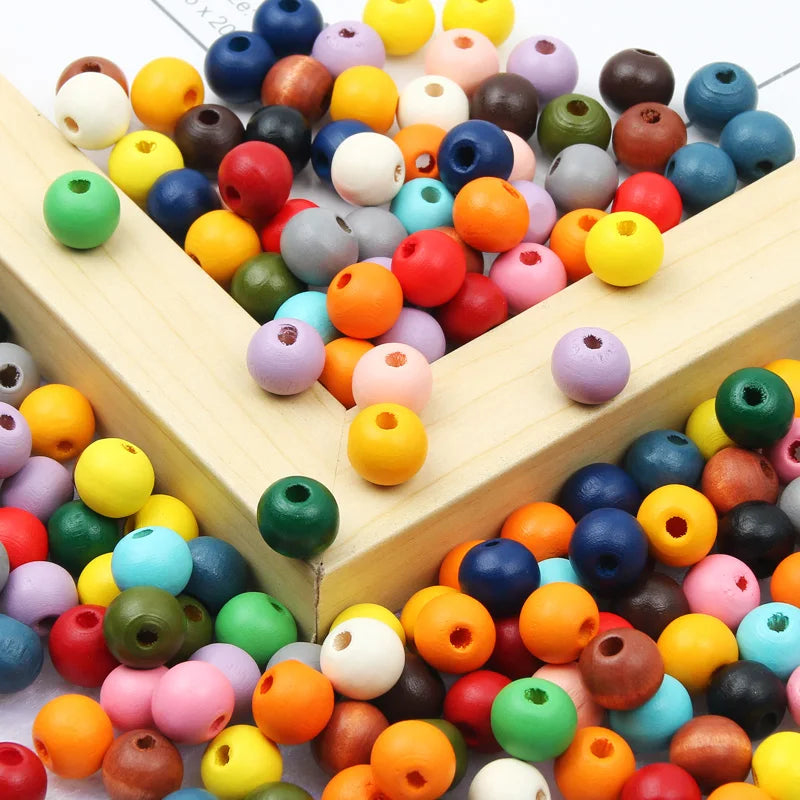 A wooden box filled with various natural colored beads for jewelry making and DIY crafts