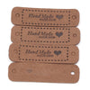 A set of four brown leather-style handmade with love tags for crafts and sewing.