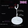A clear, adjustable doll display stand with a plastic/metal construction and a round base.
