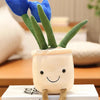 A plush stuffed toy shaped like a succulent with green leaves and blue tulip flowers