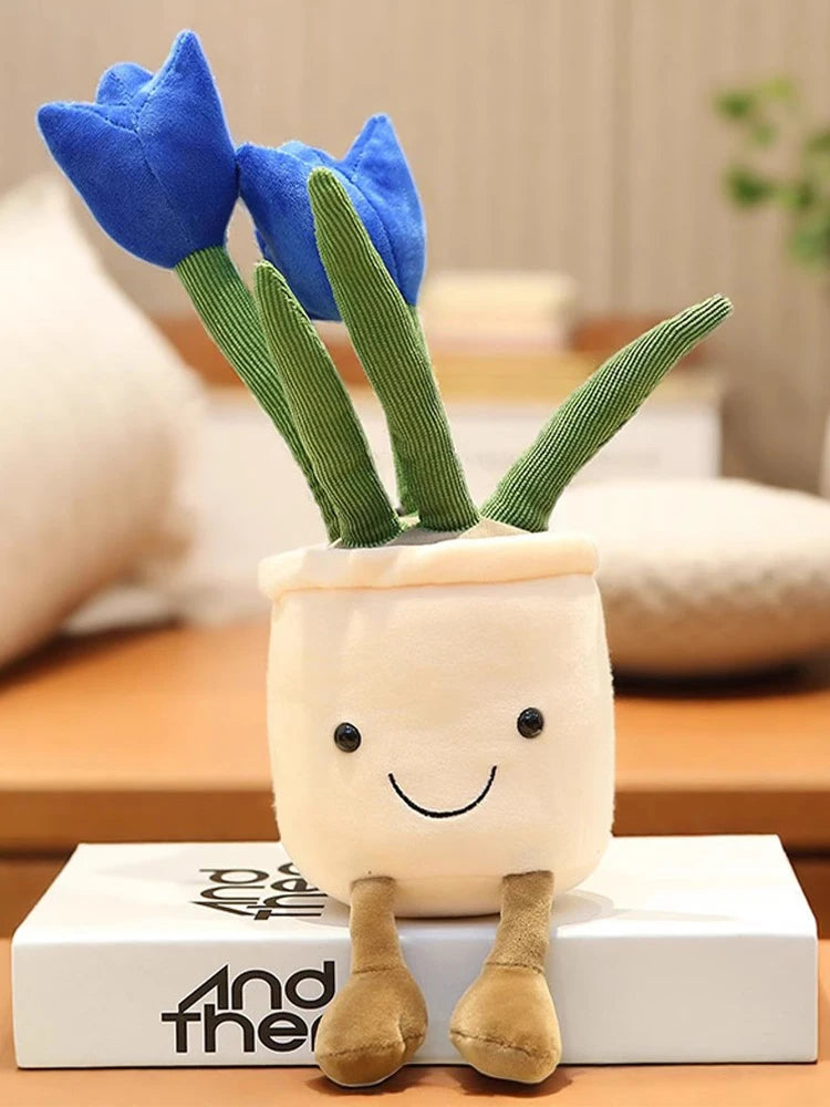 A plush stuffed toy shaped like a succulent with green leaves and blue tulip flowers