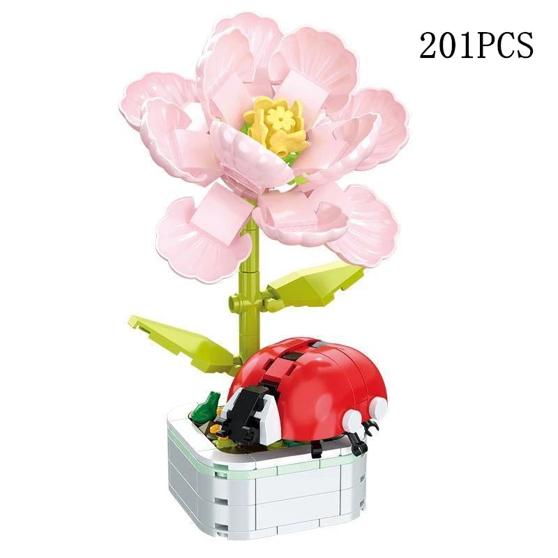 A set of 201 pink rose flower building blocks arranged in a bouquet with a red and black vehicle figure.