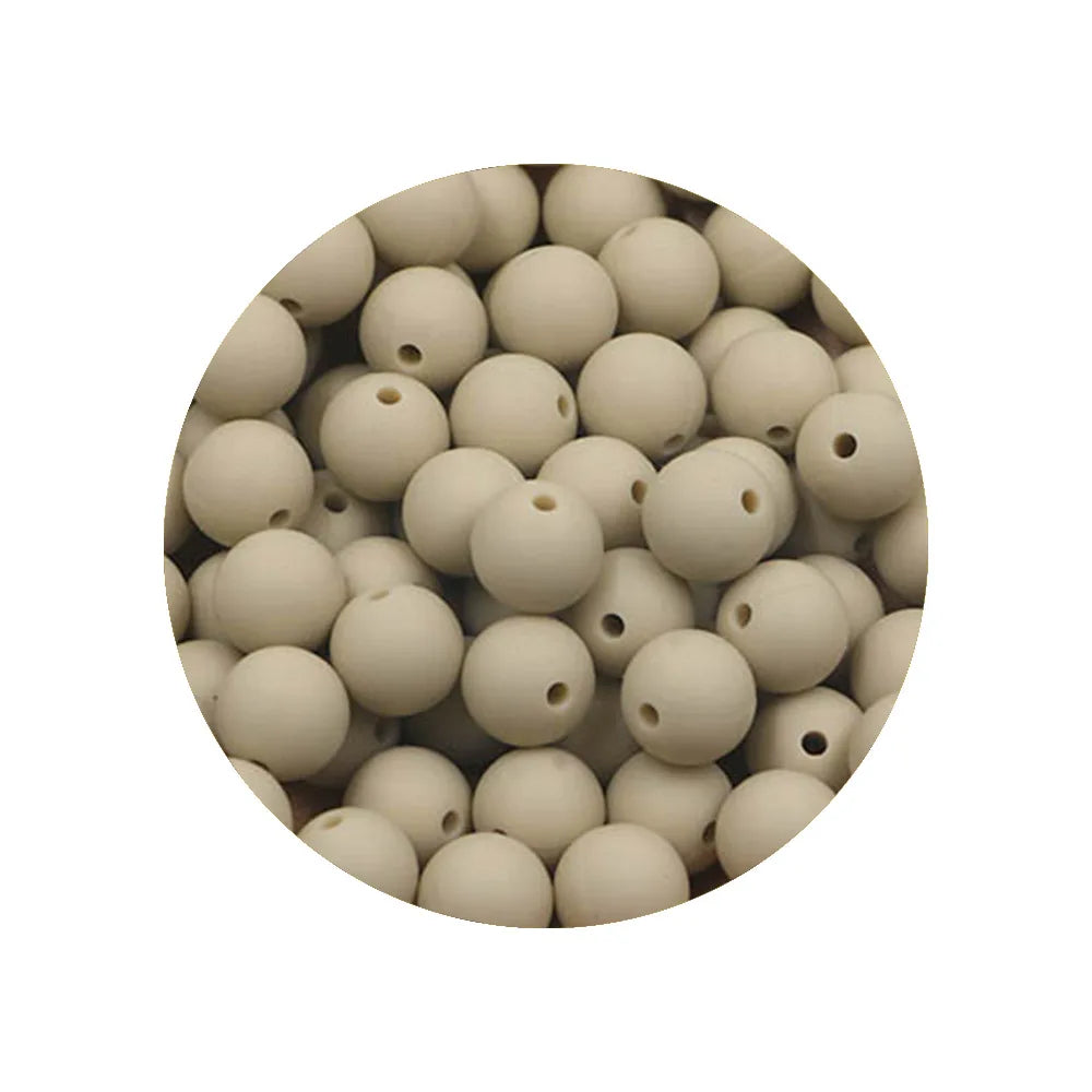 A circular arrangement of small, light-colored silicone beads in various sizes.