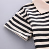 A close-up of a kids' striped outfit set featuring a black and white striped top with a light beige collar.