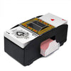 A black automatic card shuffler device with a dispenser tray and cards visible.