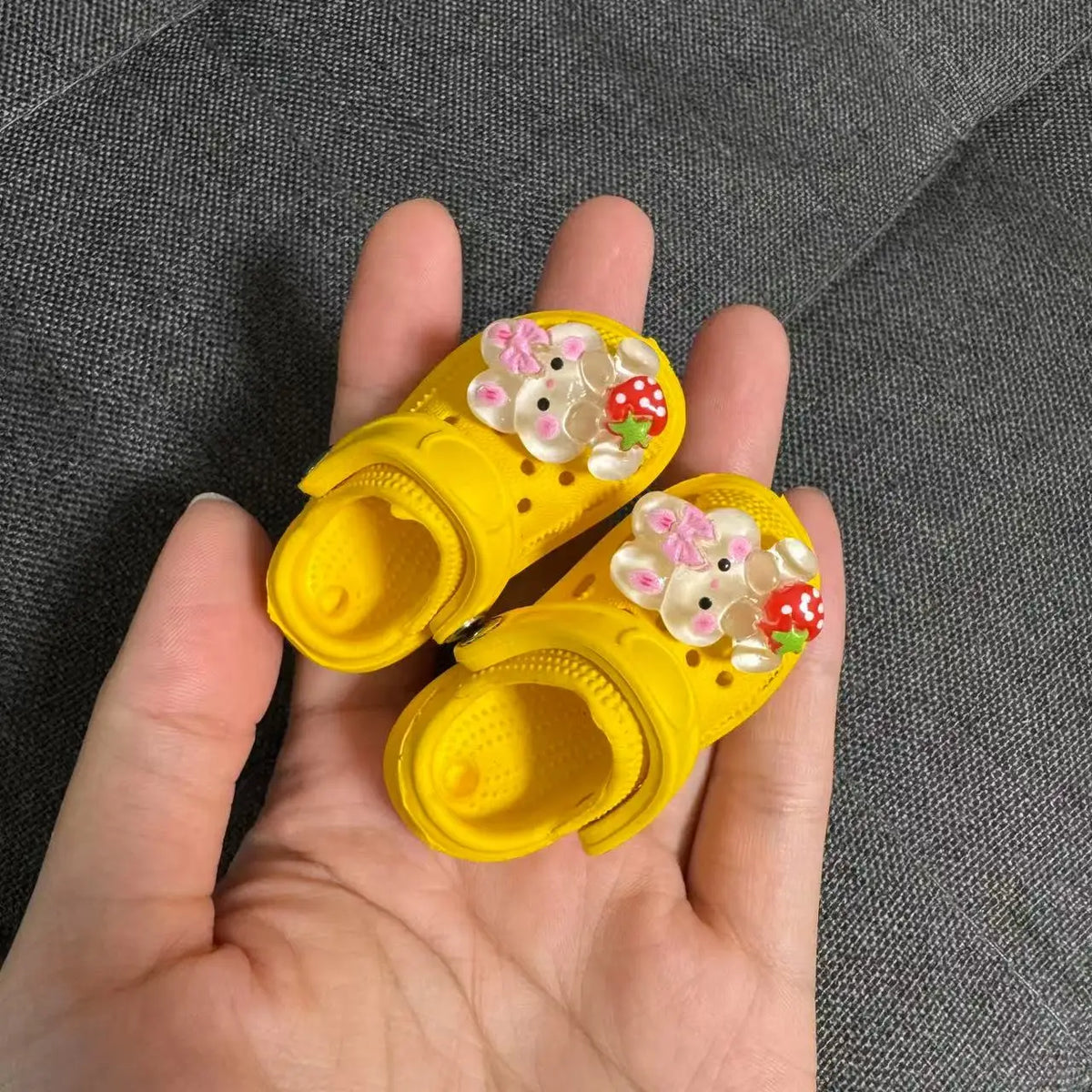 Yellow fashion slippers adorned with pink and white floral decorations for doll accessories