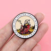 A round enamel pin featuring a stylized depiction of a bear with smoke and text around the edge.