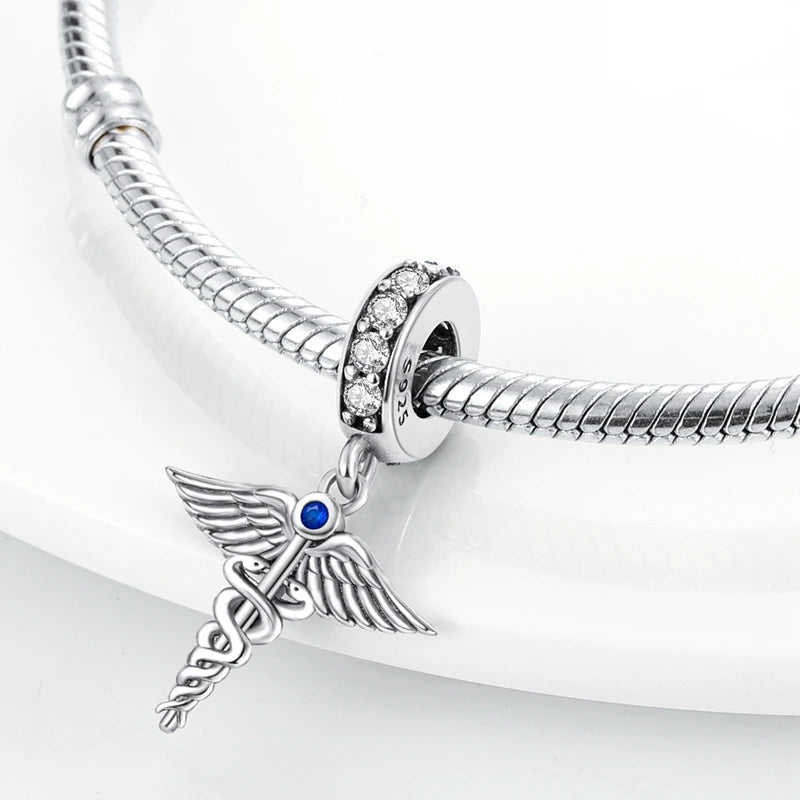 Sterling silver charm beads set featuring cross, angel, and evil eye designs for DIY jewelry making