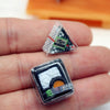 A small, clear plastic package containing miniature Japanese sushi items for a dollhouse kitchen.