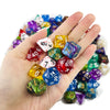 A hand holds a collection of colorful polyhedral dice used for tabletop role-playing games
